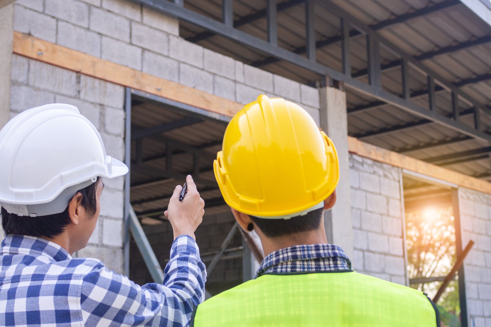 Construction Workers Inspecting a Building